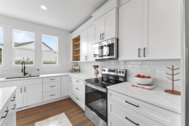 1632 20th Ave SE, Altoona, IA 50009 - kitchen featuring stainless steel appliances, a sink, tasteful backsplash, white cabinets, and recessed lighting