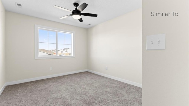 spare room featuring light colored carpet and ceiling fan