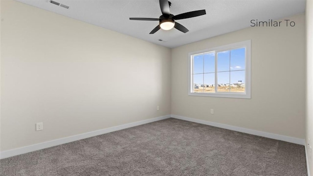 spare room featuring ceiling fan and carpet