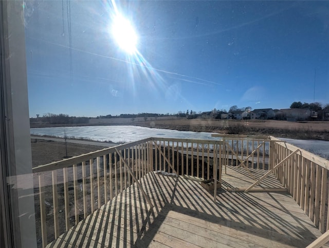 wooden terrace featuring a water view