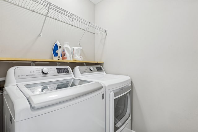 washroom featuring washing machine and dryer