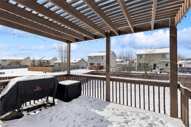 snow covered deck with a grill and a pergola