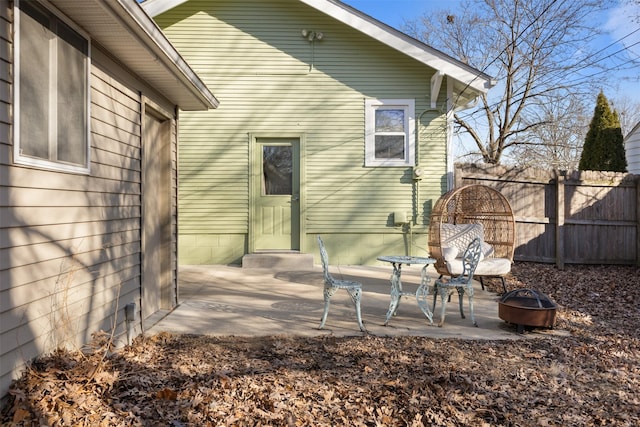 rear view of property with a patio area and a fire pit