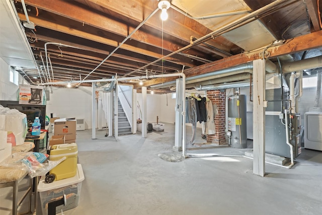 basement featuring gas water heater, washer / dryer, and heating unit