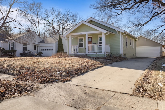 bungalow-style house with a garage and covered porch