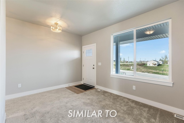 view of carpeted entrance foyer