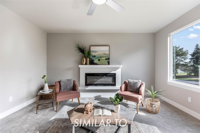 sitting room featuring ceiling fan and carpet