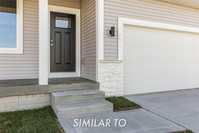 view of exterior entry with a garage