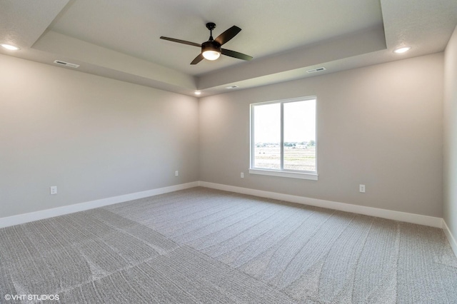 319 41st St SW, Altoona, IA 50009 - empty room with a tray ceiling, light colored carpet, a ceiling fan, and recessed lighting