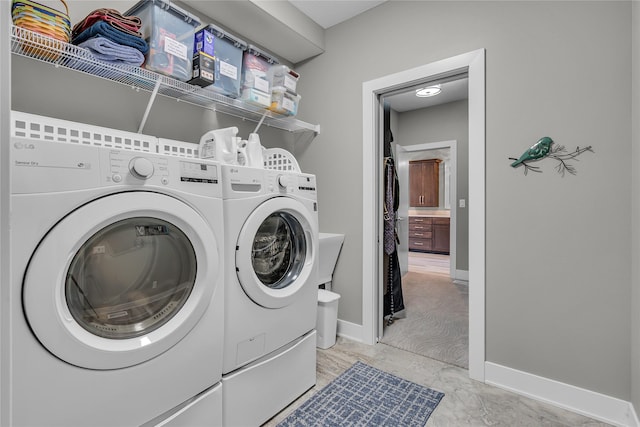 clothes washing area with washer and clothes dryer