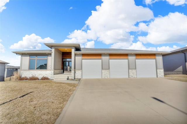 view of front of property with a garage and a front yard