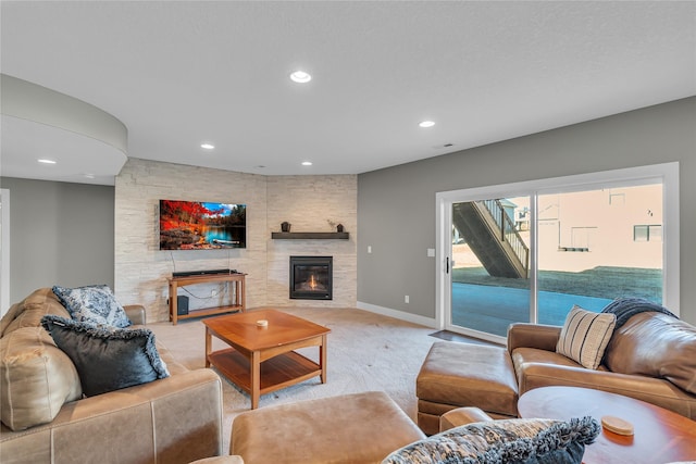 living room featuring light colored carpet and a fireplace