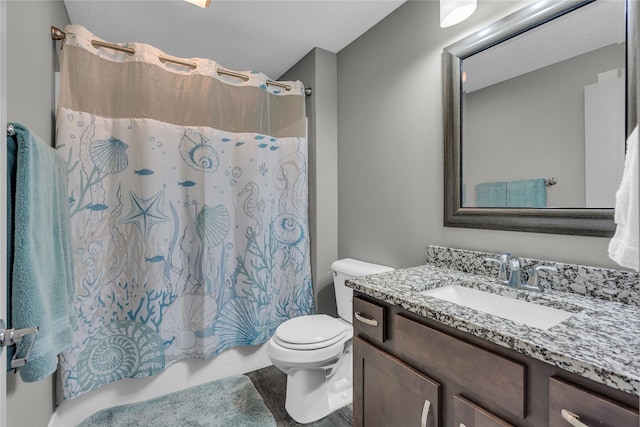 full bathroom featuring vanity, shower / tub combo with curtain, and toilet