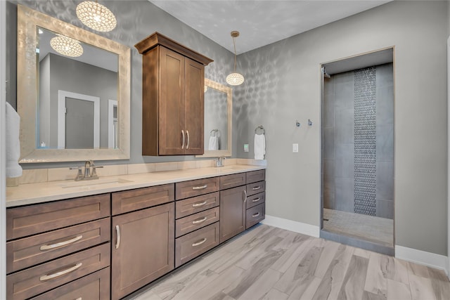 bathroom with vanity, hardwood / wood-style floors, and a tile shower