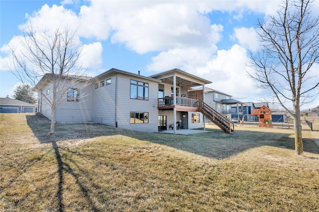 rear view of property with a playground, a patio, and a lawn