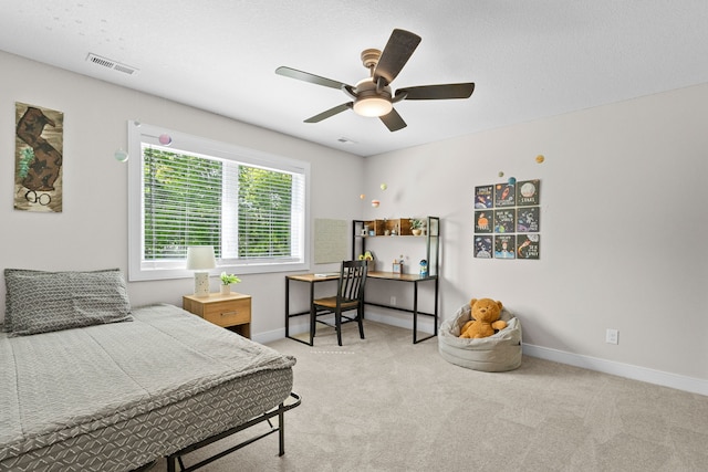 carpeted bedroom with a ceiling fan, visible vents, and baseboards