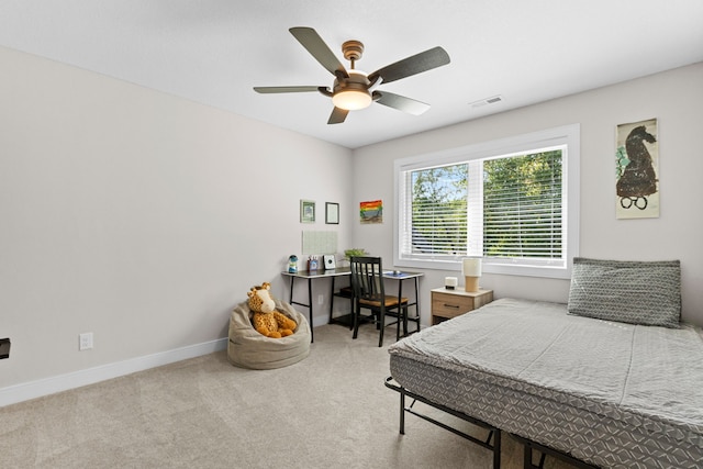 carpeted bedroom featuring baseboards, visible vents, and a ceiling fan