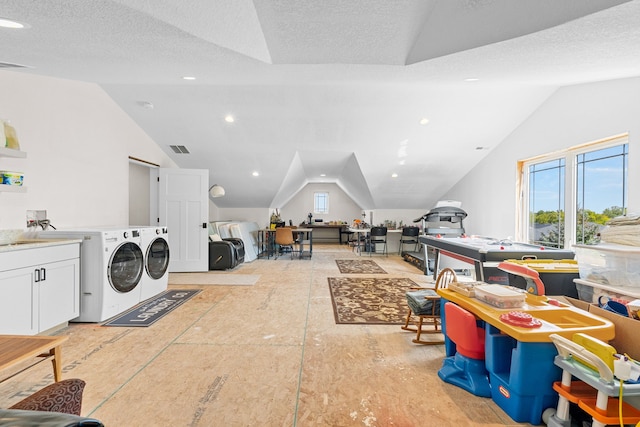 interior space featuring laundry area, a textured ceiling, visible vents, and washer and dryer