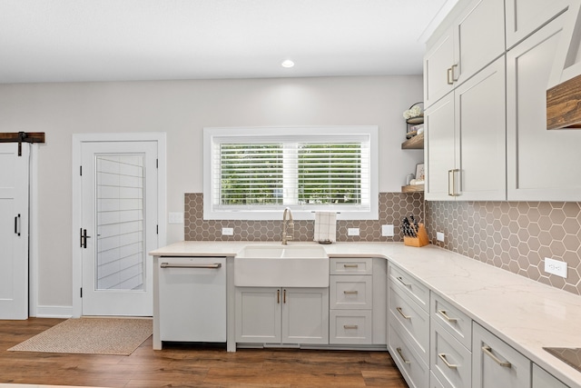 kitchen with a sink, dark wood-style floors, open shelves, and dishwasher