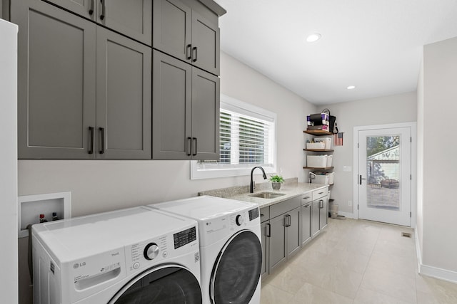 laundry area with plenty of natural light, a sink, cabinet space, and washer and dryer