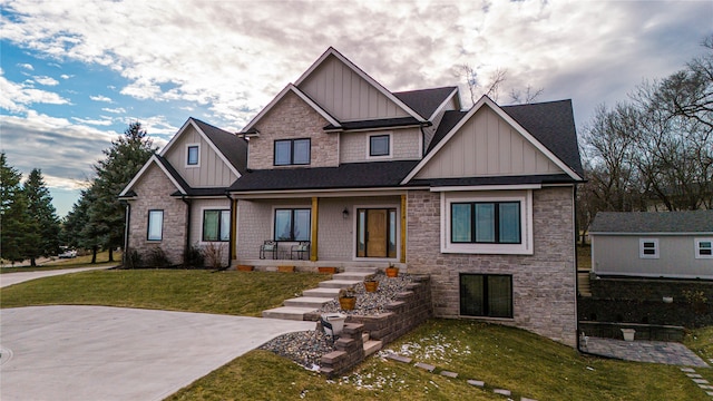 craftsman-style house with a shingled roof, board and batten siding, and a front yard