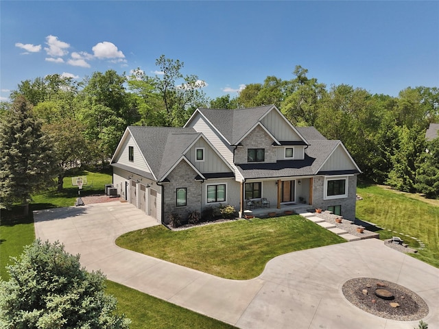 114 Tradition Dr, Polk City, IA 50226 - craftsman inspired home featuring concrete driveway, board and batten siding, covered porch, an attached garage, and a front yard