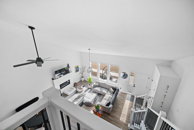 interior space with a fireplace, lofted ceiling, and wood finished floors