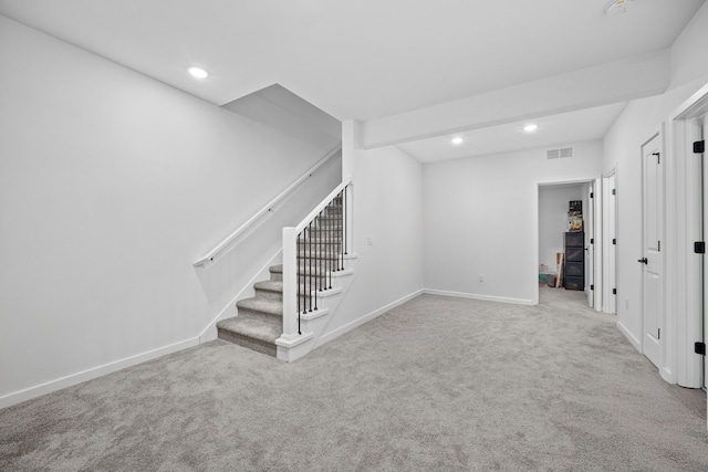 basement featuring stairway, visible vents, baseboards, recessed lighting, and carpet flooring