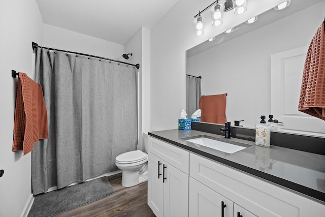 bathroom with a shower with curtain, toilet, wood finished floors, and vanity