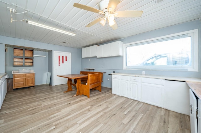 kitchen featuring white cabinets, ceiling fan, and light hardwood / wood-style flooring