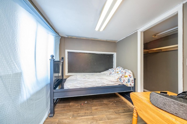 bedroom featuring dark hardwood / wood-style flooring and a closet