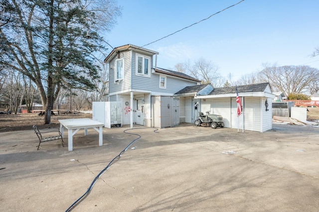 view of front of home with a garage and a patio area