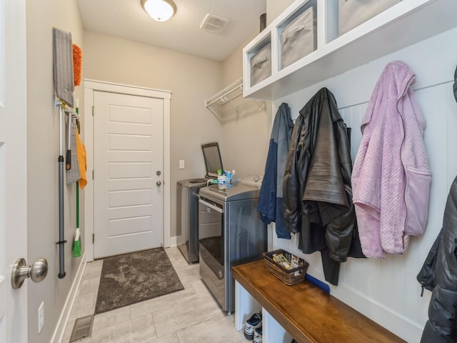 interior space with washer and clothes dryer and a textured ceiling