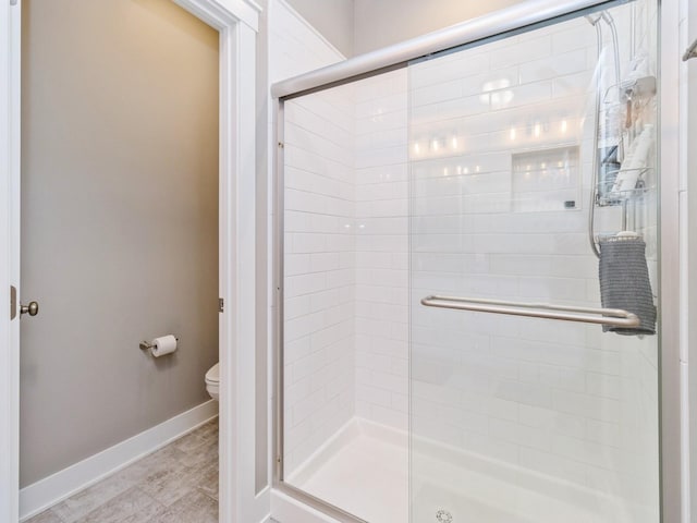 bathroom featuring toilet and walk in shower