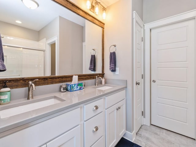 bathroom with vanity and a shower with shower door