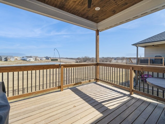 wooden terrace featuring ceiling fan