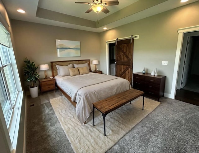 1837 15th Ave SE, Altoona, IA 50009 - carpeted bedroom featuring a barn door, recessed lighting, a tray ceiling, baseboards, and ceiling fan