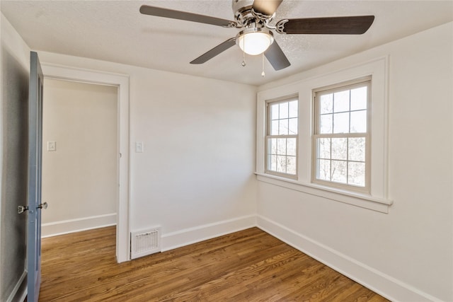 spare room with wood-type flooring and a textured ceiling