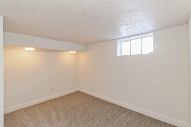 basement with carpet flooring and a textured ceiling