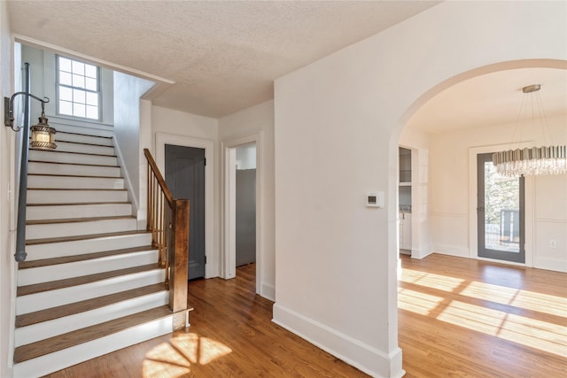 entrance foyer with hardwood / wood-style flooring and a textured ceiling