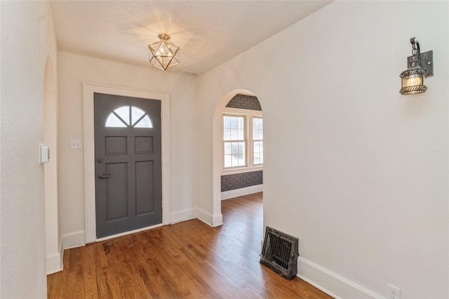 foyer featuring wood-type flooring and a chandelier