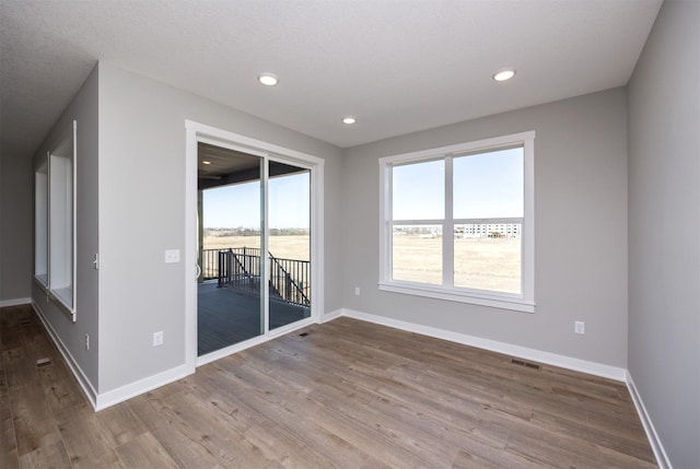 spare room with light hardwood / wood-style floors