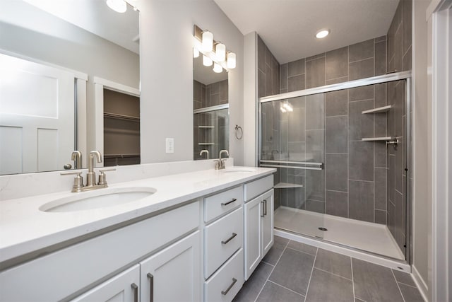 bathroom featuring vanity, an enclosed shower, and tile patterned flooring