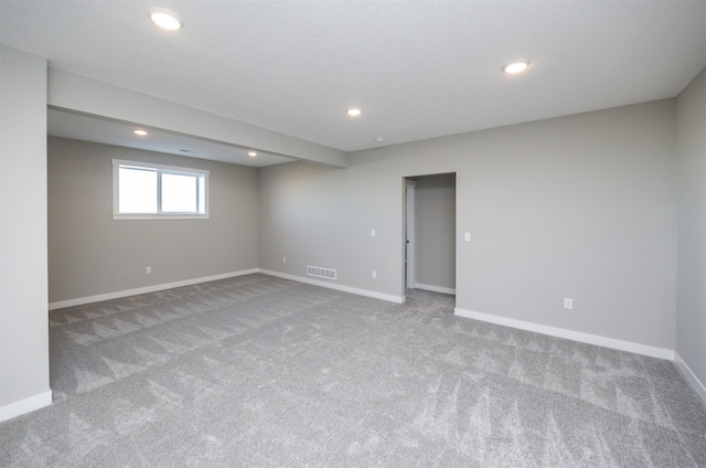 basement featuring light carpet