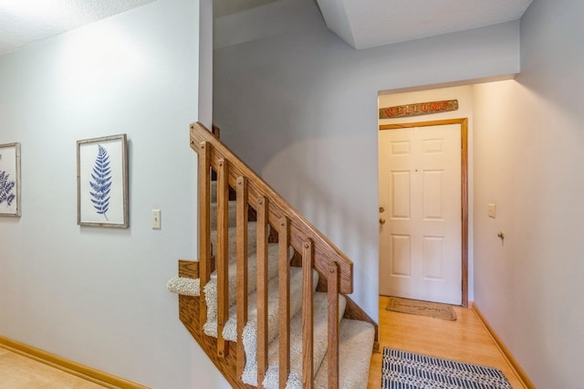 stairs with hardwood / wood-style flooring