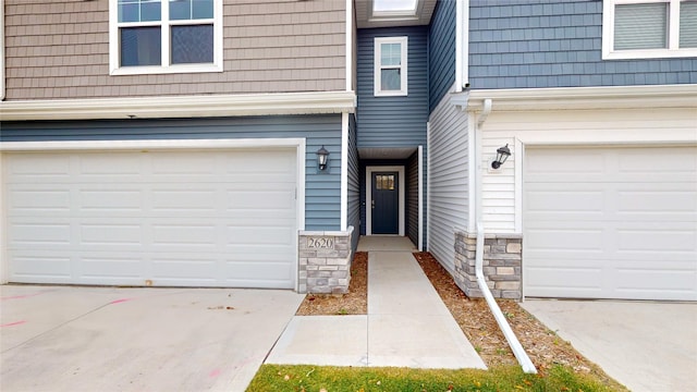 doorway to property with a garage