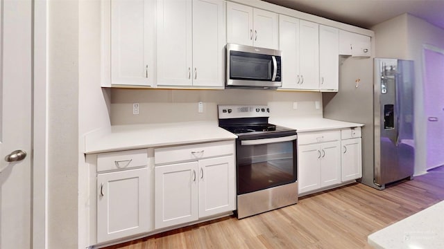 kitchen featuring white cabinetry, appliances with stainless steel finishes, and light hardwood / wood-style floors