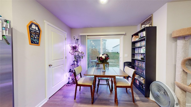 dining space featuring wood-type flooring