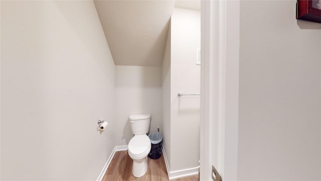 bathroom featuring hardwood / wood-style flooring and toilet