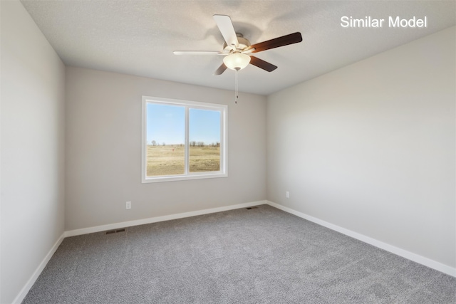 carpeted empty room featuring a textured ceiling and ceiling fan